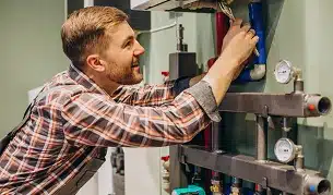 Young engineer adjusting autonomous heating