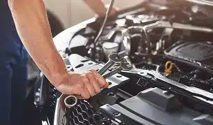 Picture showing muscular car service worker repairing vehicle